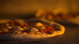 Craft Pizza Cooking in Brick Oven