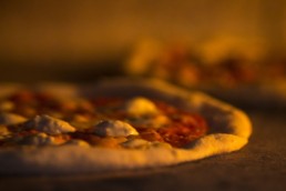 Craft Pizza Cooking in Brick Oven