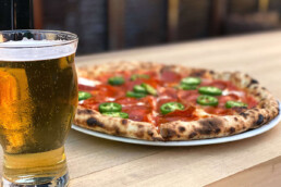 Beer page - craft beer next to wood-fired pizza